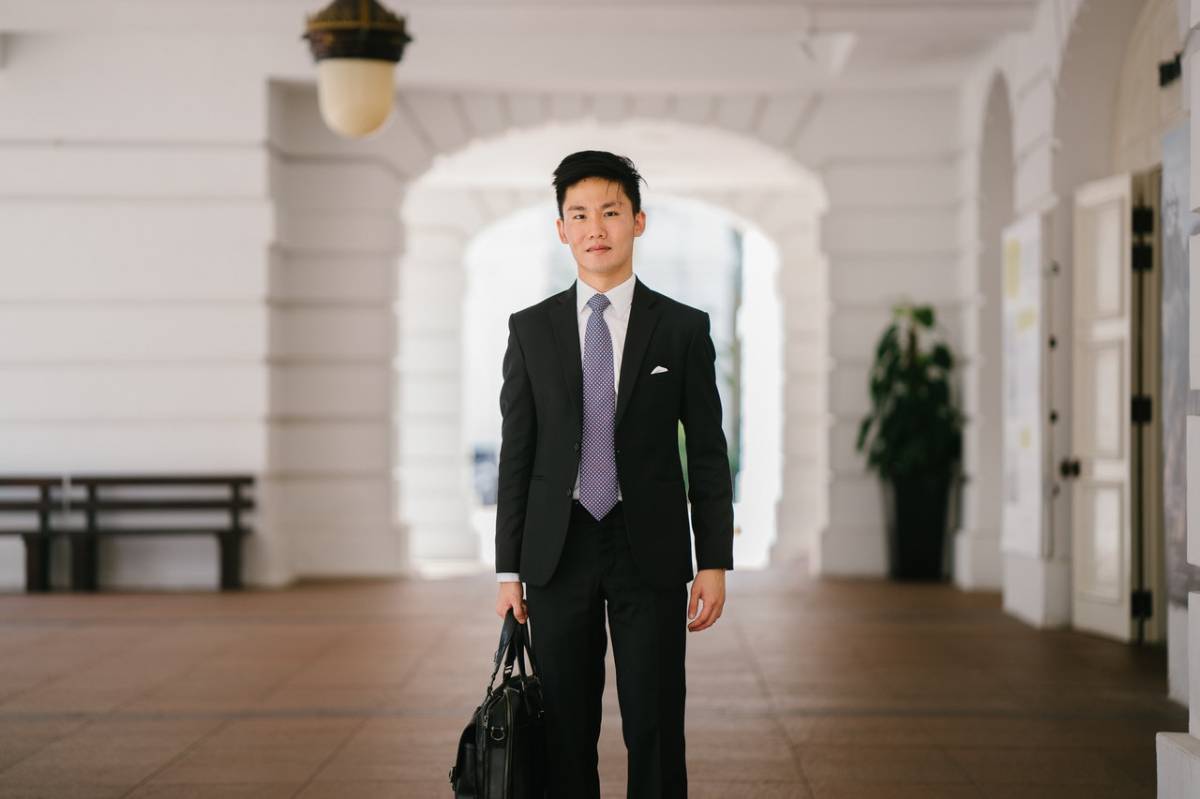 A man wearing black suit jacket and pants